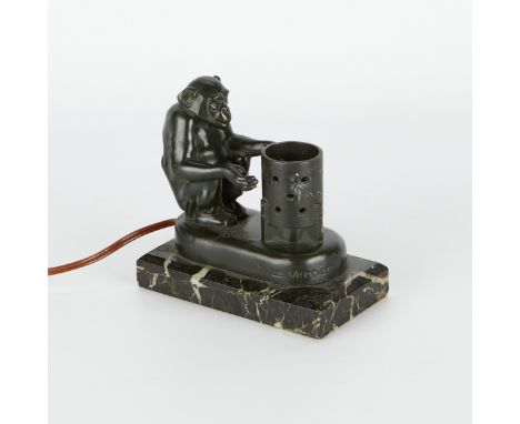 Louis Octave Maxime "Max" Le Verrier (French,1891-1973). Art deco spelter patinated lamp in the form of a chimpanzee warming 