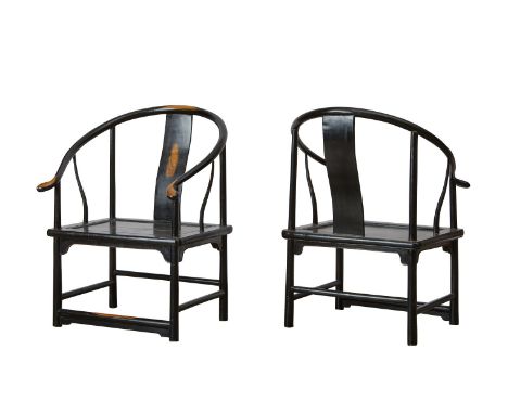 Pair of Chinese low horseshoe-back chairs. Of a dark-stained wood with curved backsplats, with panel seats set in rectangular