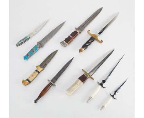 Group of nine knives and daggers including:Two matching Daniel Valois daggers with stainless steel tapered blades, curved gua