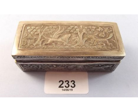 An Indian white metal snuff box embossed beasts, 8cm wide