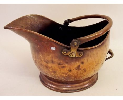 A 19th century copper helmet form coal scuttle