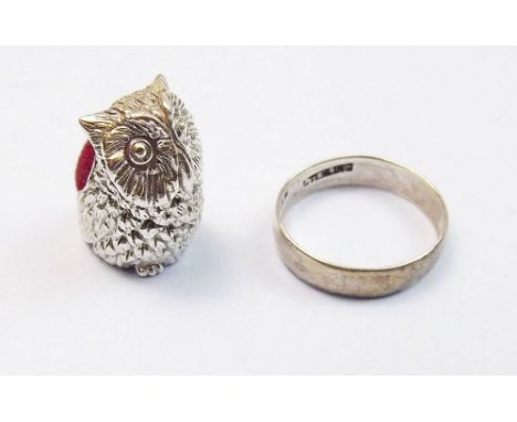A silver ring and a miniature silver owl pin cushion