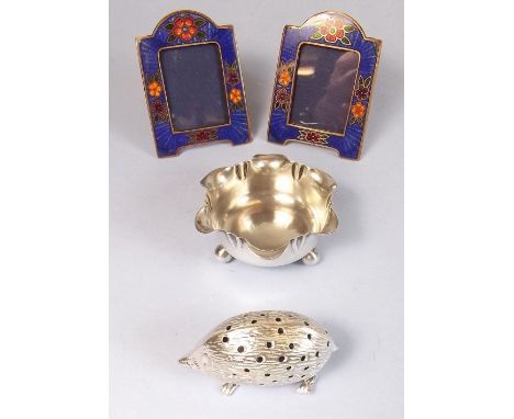 A silver hedgehog novelty pin cushion, a silver salt and two miniature enamel photograph frames