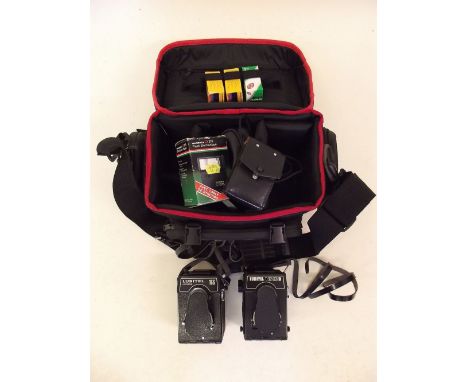 A Lubitel Universal 166 camera and a Lubitel 166B camera with accessories