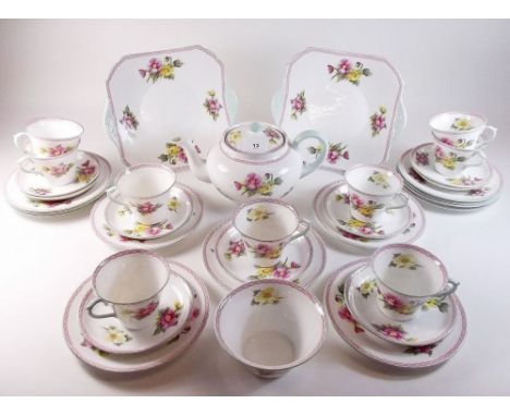 A Shelley floral painted tea service comprising teapot, nine cups and saucers, two cake plates and twelve tea plates and suga