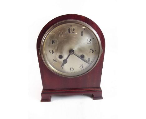 An Edwardian mahogany arch top mantel clock