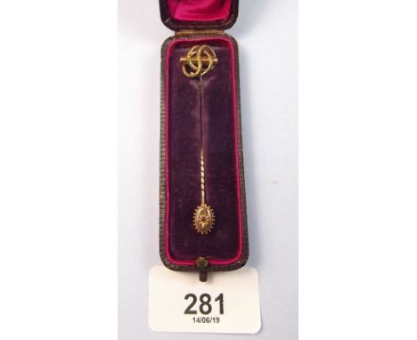 A Victorian 15 ct gold stick pin set ruby and a Victorian yellow metal knot stick pin in fitted case