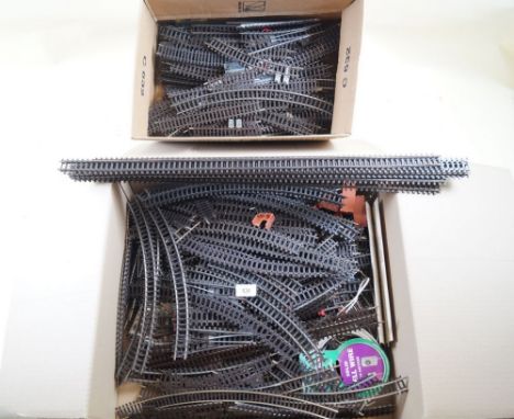 A quantity of 00 gauge model railway track including curves, curved points, straights etc