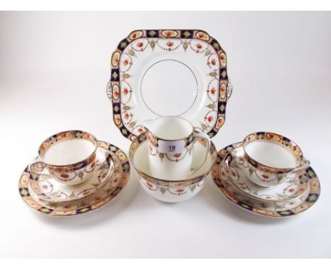 An Edwardian Gladstone tea service comprising ten cups and saucers, ten tea plates, cake plate, milk and sugar