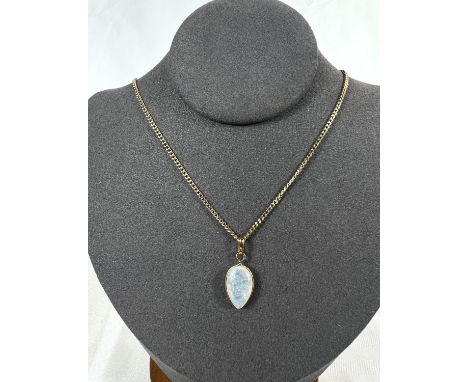 A 9ct hallmarked gold fine curb link chain with teardrop shaped pendant of pale milky opal, gross 4gm.