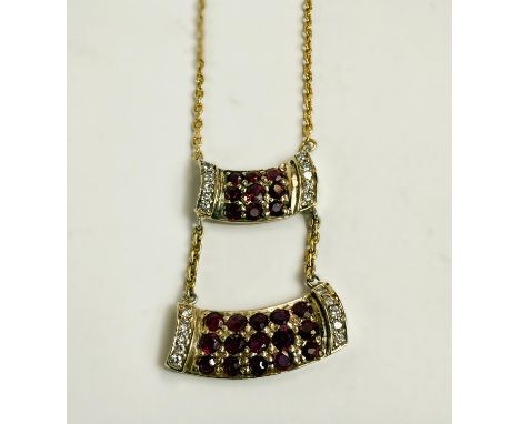 A ruby and diamond pendant on a fine gold chain, formed from 2 horizontal bars, the top set with 9 rubies and 10 small diamon
