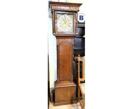 A V. Wilson Kendal, oak cased grandfather clock with brass dial with moon phase, signed with inlaid decoration.