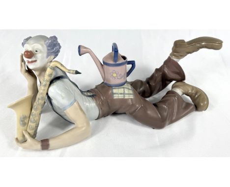 A Lladro clown/musician reclining with saxophone and watering can. Length 31cm