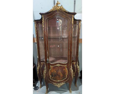 A Louis XV style Kingwood vitrine with extensive ormolu beading and mounts, the single door lower section is painted in the "