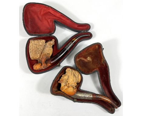 2 cases amber and Meerschaum pipes, one in the form of a bear with a basket on its back, length 16cm; the second: a bearded A