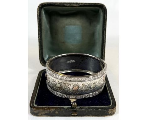 An antique broad bangle with gold highlights, stamped Sterling Silver.