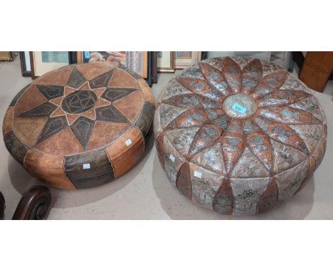 A Middle Eastern patterned leather pouffe cushion and another.