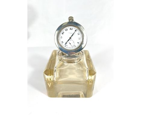 A cut glass library desk inkwell with silver pocket watch mounted to the lid with mechanism for it to stand and show the time