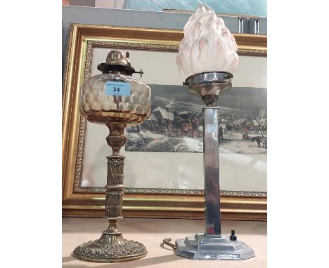 An ornate Victorian brass oil lamp with glass reservoir; an Art Deco chrome table lamp with flame glass shade (shade a/f).