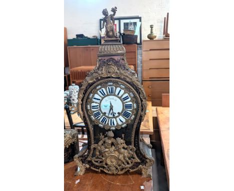 A large Louis XV style Rococo Boulle work bracket clock of waited form with cherub finial and extensive cherub and acanthus m
