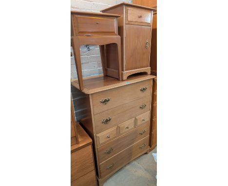 A Stag&nbsp; light oak chest&nbsp; of 4 long and 3 short drawers, a dressing table and bedside cupboards