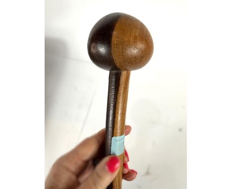 A carved wooden two tone knobkerrie