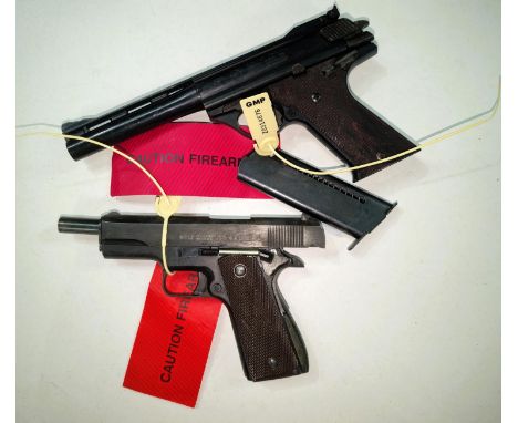 A reproduction model of a Colt 45 and another reproduction handgun