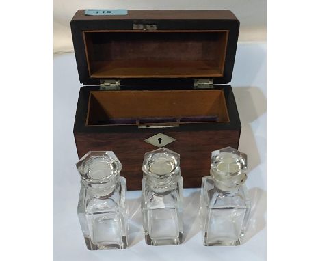 A stained wood domed caddy fitted with three glass perfume bottles.