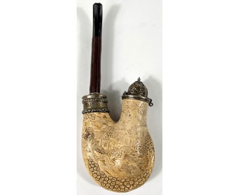 A large Meerschaum pipe with silver lid and collar, cherrywood stem with extensive relief decoration depicting deer in a rura