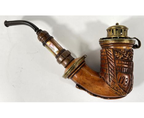 A Meerschaum pipe with black mouthpiece, mother of pearl inlaid stem, silvered metal cover and mounts and relief decoration o