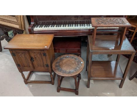 A carved oak stool/occasional table, another table, another stool, cabinet and lamp.