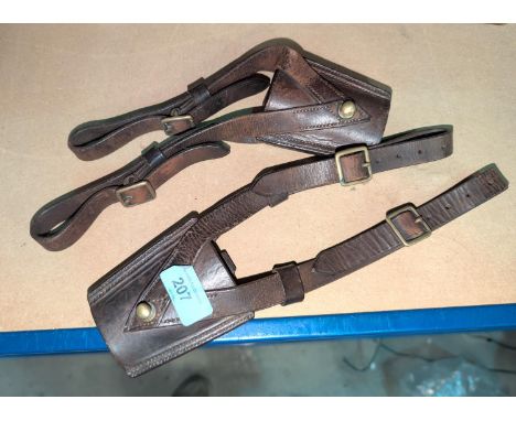A pair of leather British military sword frogs with broad arrow marks.