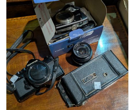 An Olympus vintage SLR camera, lenses, accessories and related items.