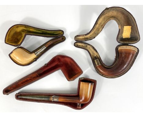 3 cased amber and Meerschaum pipes, including drop chin bowl (no mouth piece); elongated pipe (mouth piece cracked) and a sim