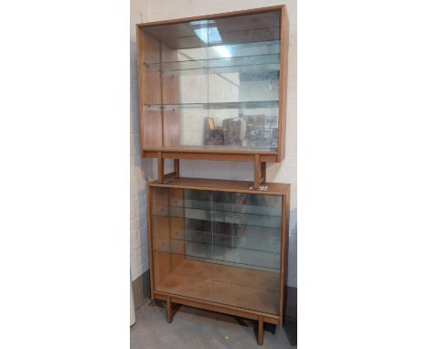 A pair of mid 20th century light oak, glass sliding door, book cases.