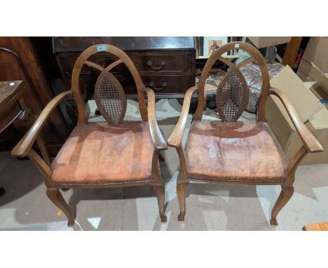 A pair of 1950's arch back arm chairs with studded leather seats&nbsp;