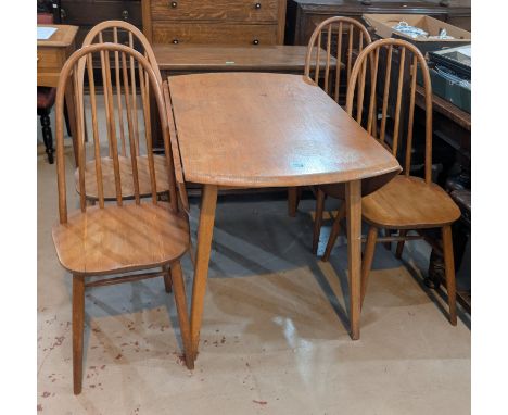 An Ercol light elm and beech dining suite comprising oval drop leaf table and 4 hoop and stick back chairs