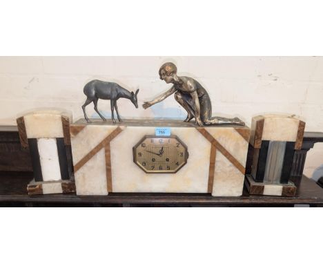 An Art Deco inlaid marble mantel clock surmounted by bronzed figures, girl feeding a lamb, width 47cm.