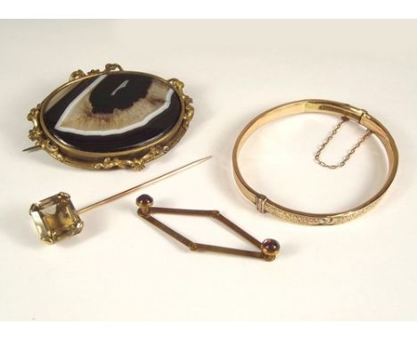 BANDED AGATE ETC.
A 19th century banded agate brooch, 6 x 4.5cm., a hinged bangle etc.