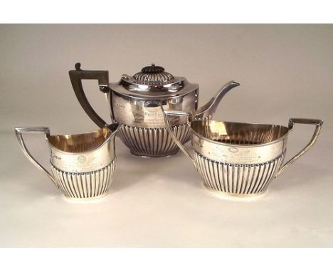 SILVER TEA WARE.
Three pieces of presentation tea ware, comprising a 1905 North Road Cycling Club teapot (Sheffield 1904), a 