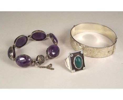 SILVER JEWELLERY.
A heavy engraved silver bangle, an amethyst set bracelet & a large modern silver ring.