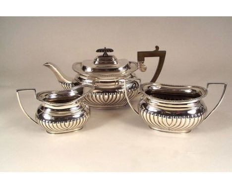 SILVER TEA SERVICE.
An Edwardian half fluted silver tea service. Sheffield 1906. 40oz.