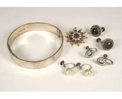 COSTUME JEWELLERY.
A hinged silver bangle, three pairs of earrings & a brooch/pendant.