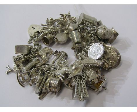 LARGE SILVER CHARM BRACELET, many charms including Roadrunner, Seahorse, alarm clock, elephant, cathedral, hatching egg, clow