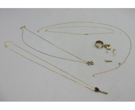 9ct yellow gold necklace with pendant set with red stone, another 9ct yellow gold necklace set with pendant, two 9ct gold cha