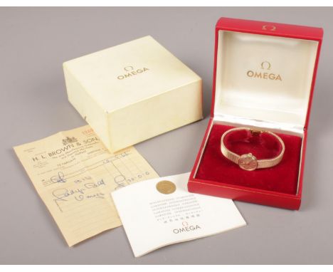A ladies 9ct gold Omega manual wristwatch. With box and papers. (gross weight 25.1g).  