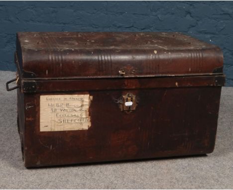 A vintage dome top twin handled tin trunk.  