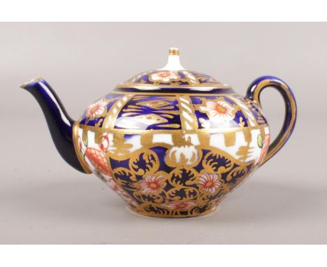 A Royal Crown Derby miniature teapot. Imari pattern, 6299, 6cm height, marks to base and under teapot lid.  Repair to lid