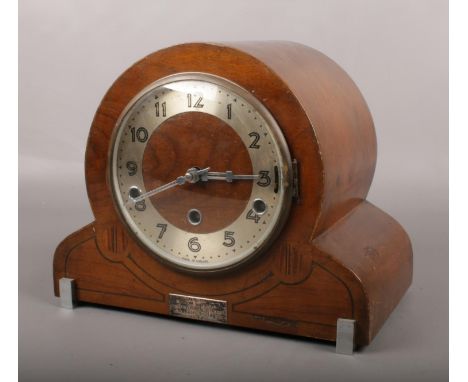 An Art Deco Norland inlaid mahogany cased mantel clock. Westminster and Whittington chiming. Presentation plaque to front.  A
