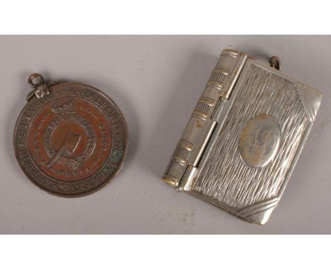 A Butchers Association medal along with a silver plate vesta case.  